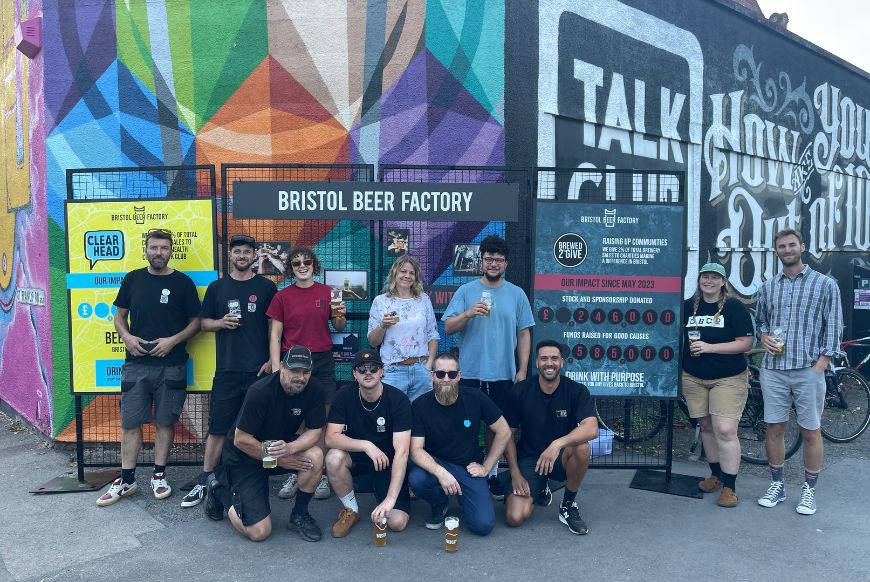 people posing with beer in hand